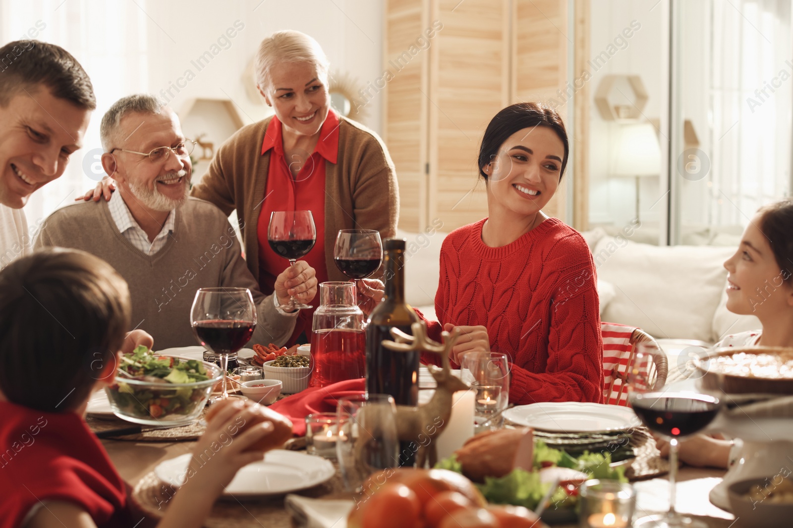 Photo of Happy family enjoying festive dinner at home. Christmas celebration