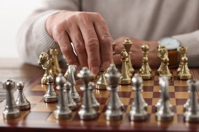 Photo of Man playing chess during tournament at chessboard, closeup