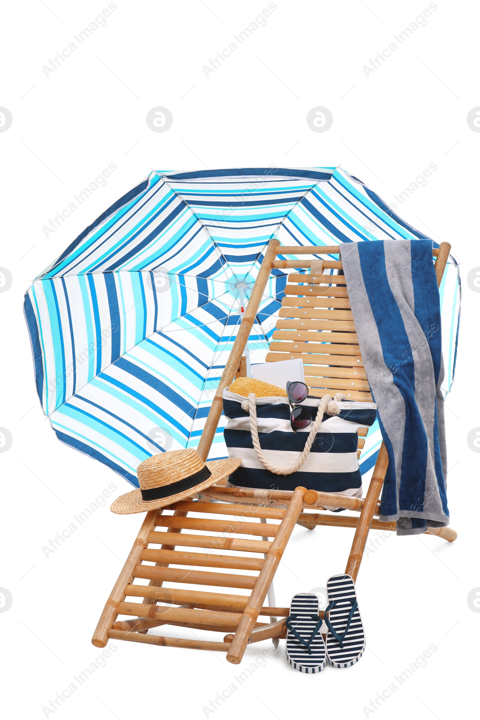 Deck chair, umbrella and other beach accessories isolated on white Photo of Deck chair, umbrella and other beach accessories isolated on white