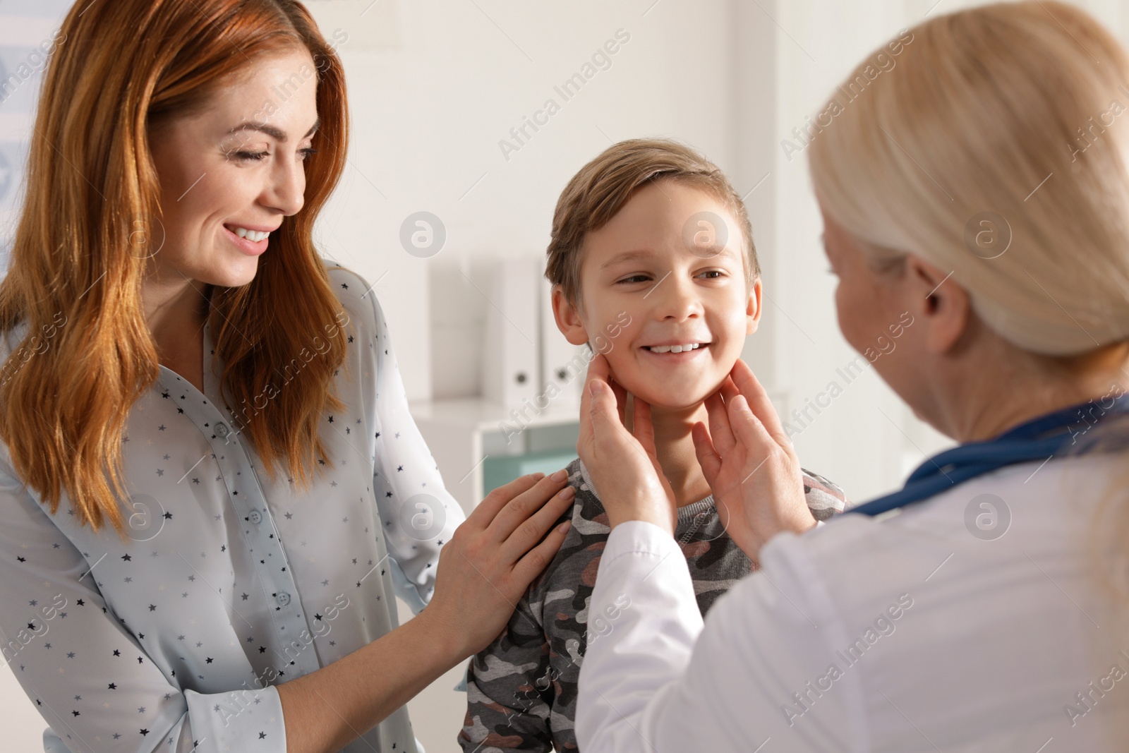 Photo of Mother with child visiting doctor in hospital