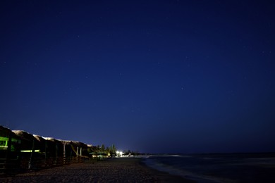 Photo of Picturesque view of starry sky at night on seaside