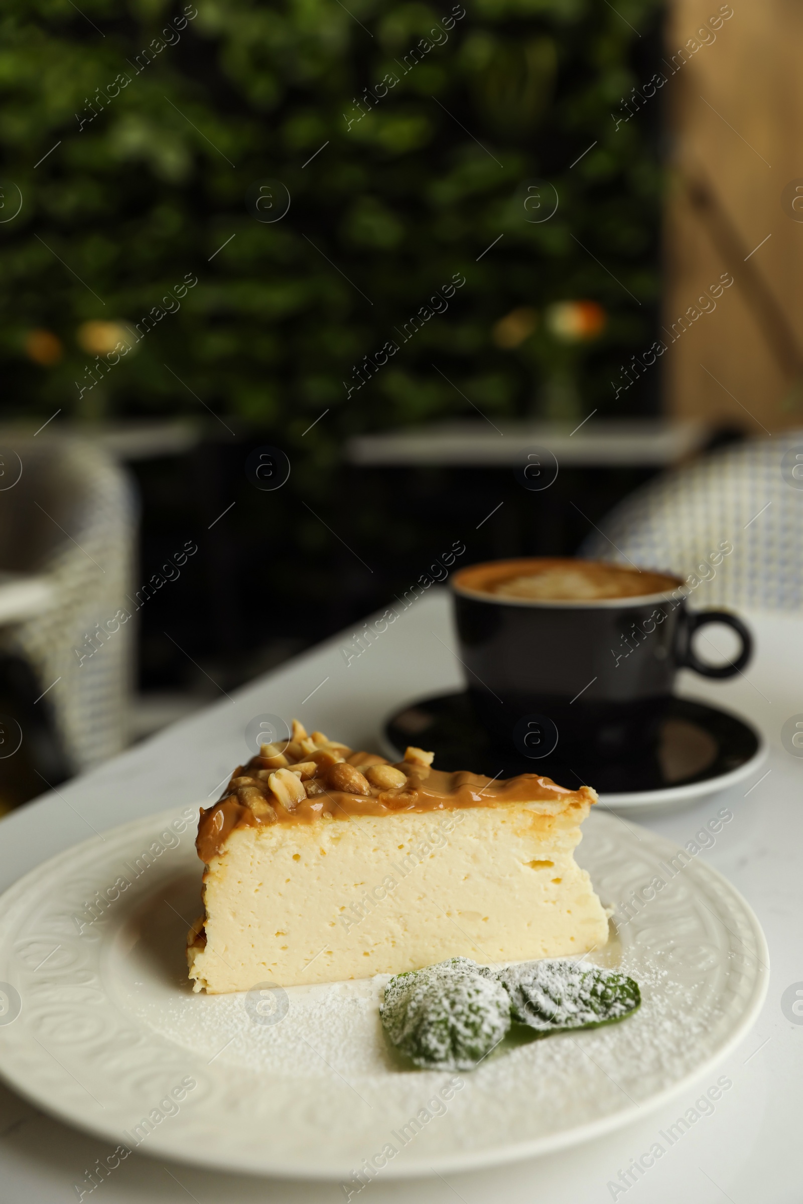 Photo of Tasty dessert and cup of fresh coffee on table in cafeteria