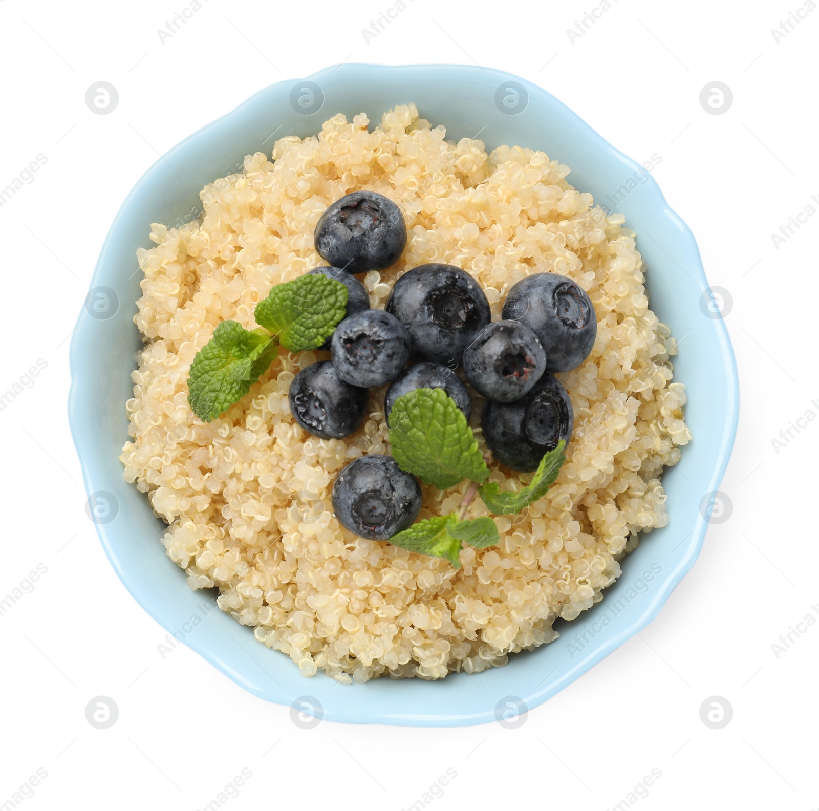 Photo of Tasty quinoa porridge with blueberries and mint in bowl isolated on white, top view