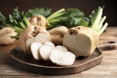 Cut sugar beets on wooden table, closeup