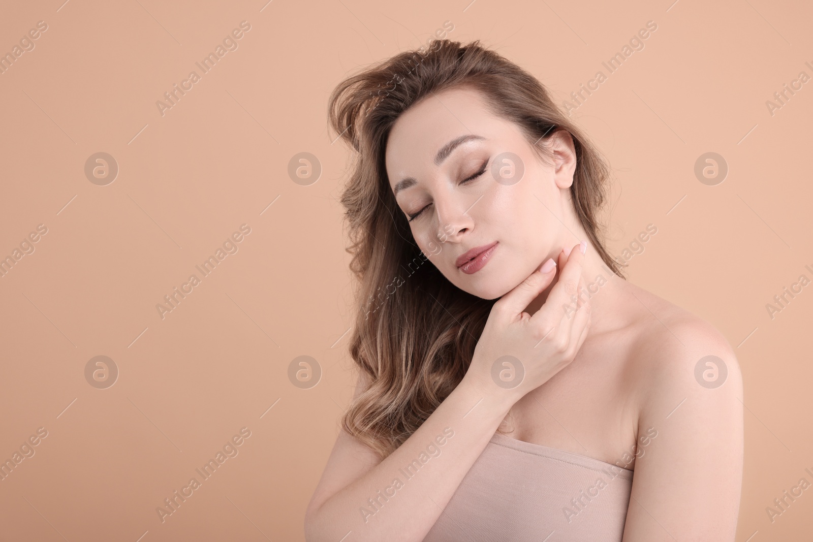 Photo of Portrait of beautiful woman on beige background. Space for text