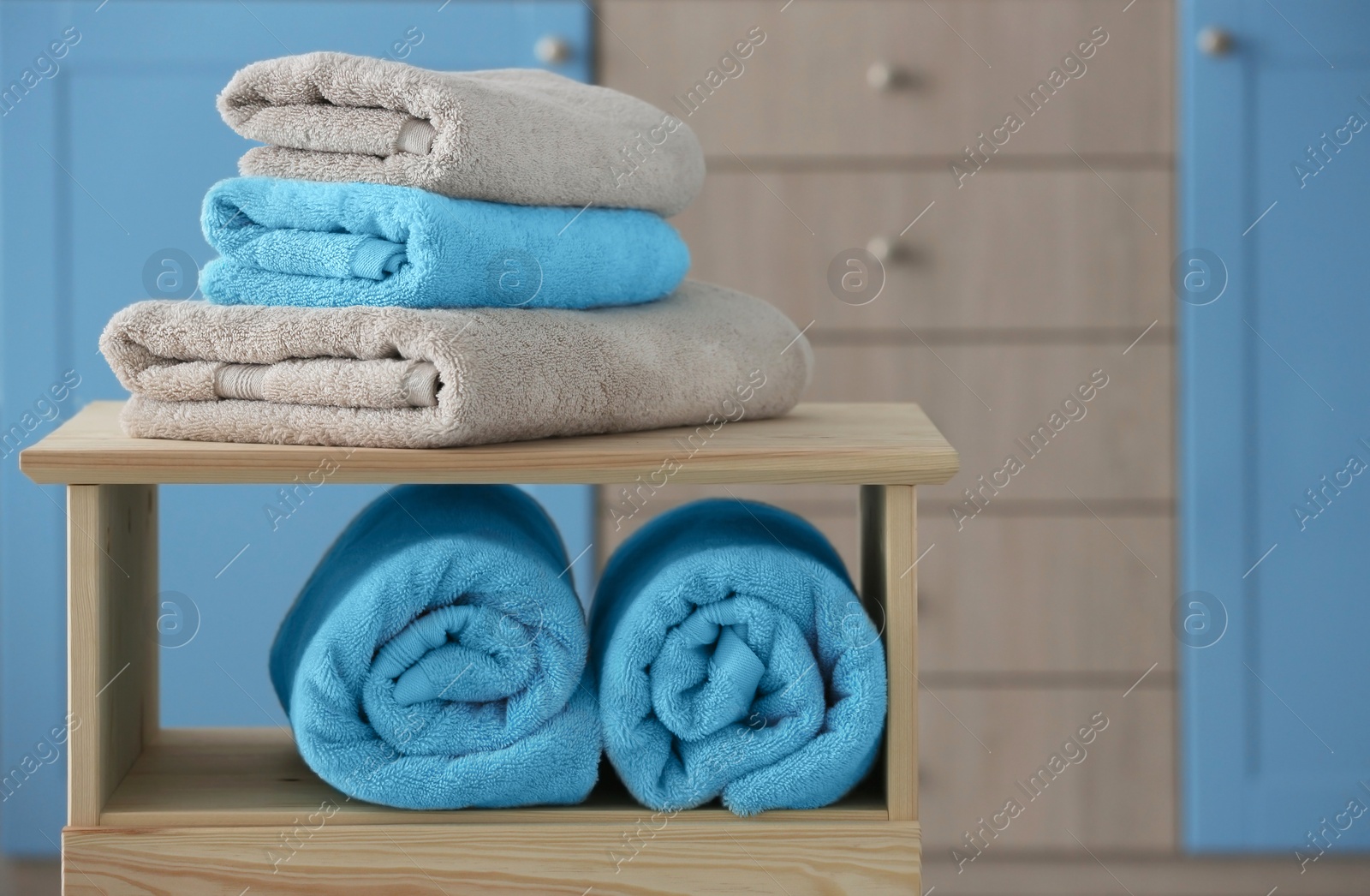 Photo of Stack of clean towels on shelves indoors