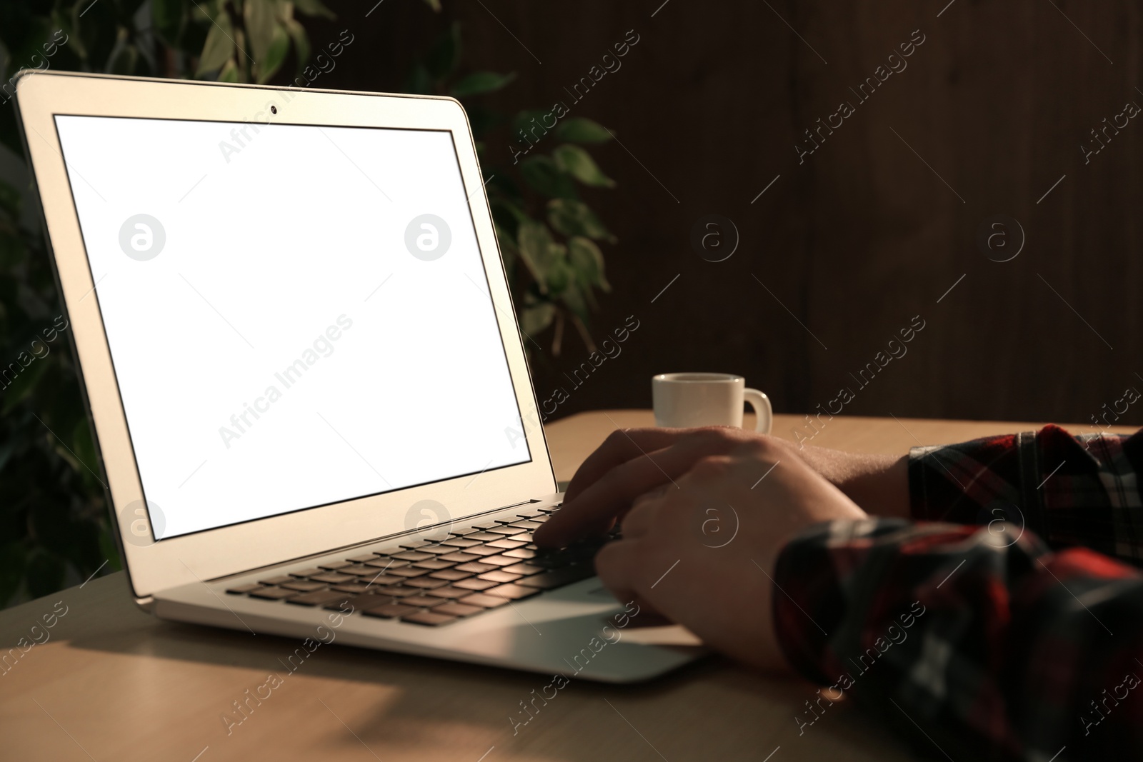 Photo of Woman using laptop at desk in office, closeup. Space for design