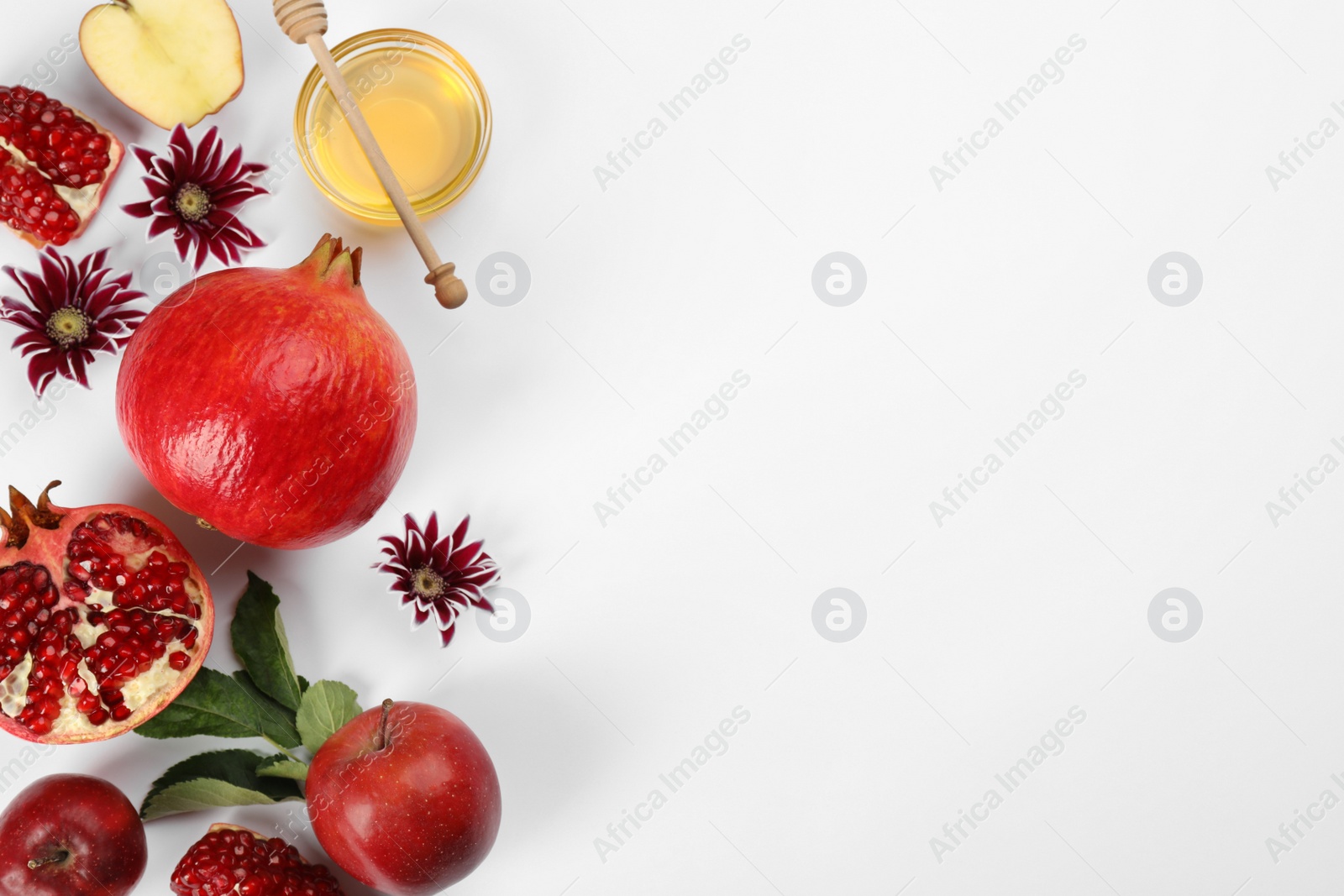 Photo of Flat lay composition with Rosh Hashanah holiday attributes on white background. Space for text