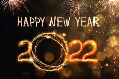 Image of Bright text Happy New 2022 Year made of firework on dark background. Greeting card design