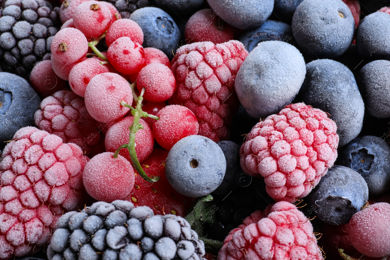 Photo of Mix of different frozen berries as background, top view