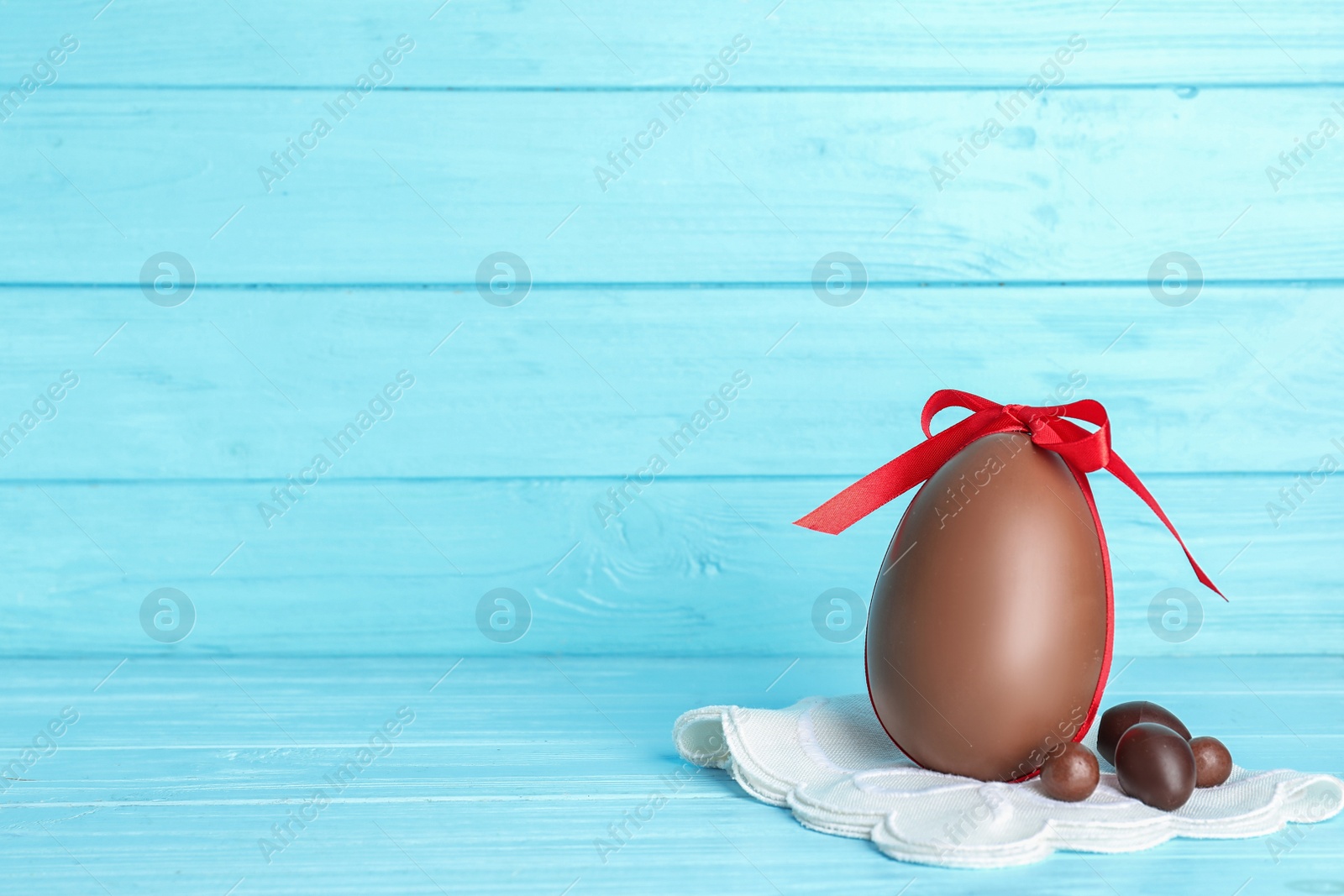 Photo of Composition with chocolate Easter eggs on table. Space for text