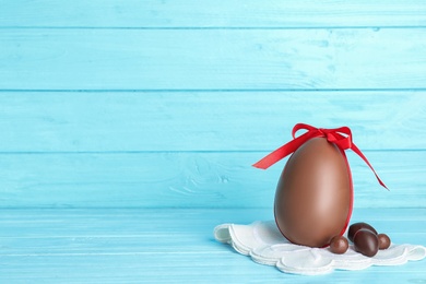 Photo of Composition with chocolate Easter eggs on table. Space for text