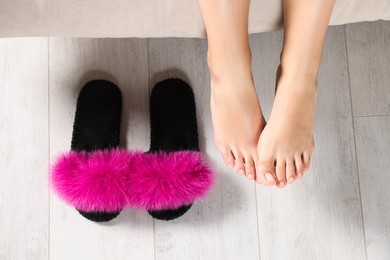 Photo of Woman with soft slippers at home, top view