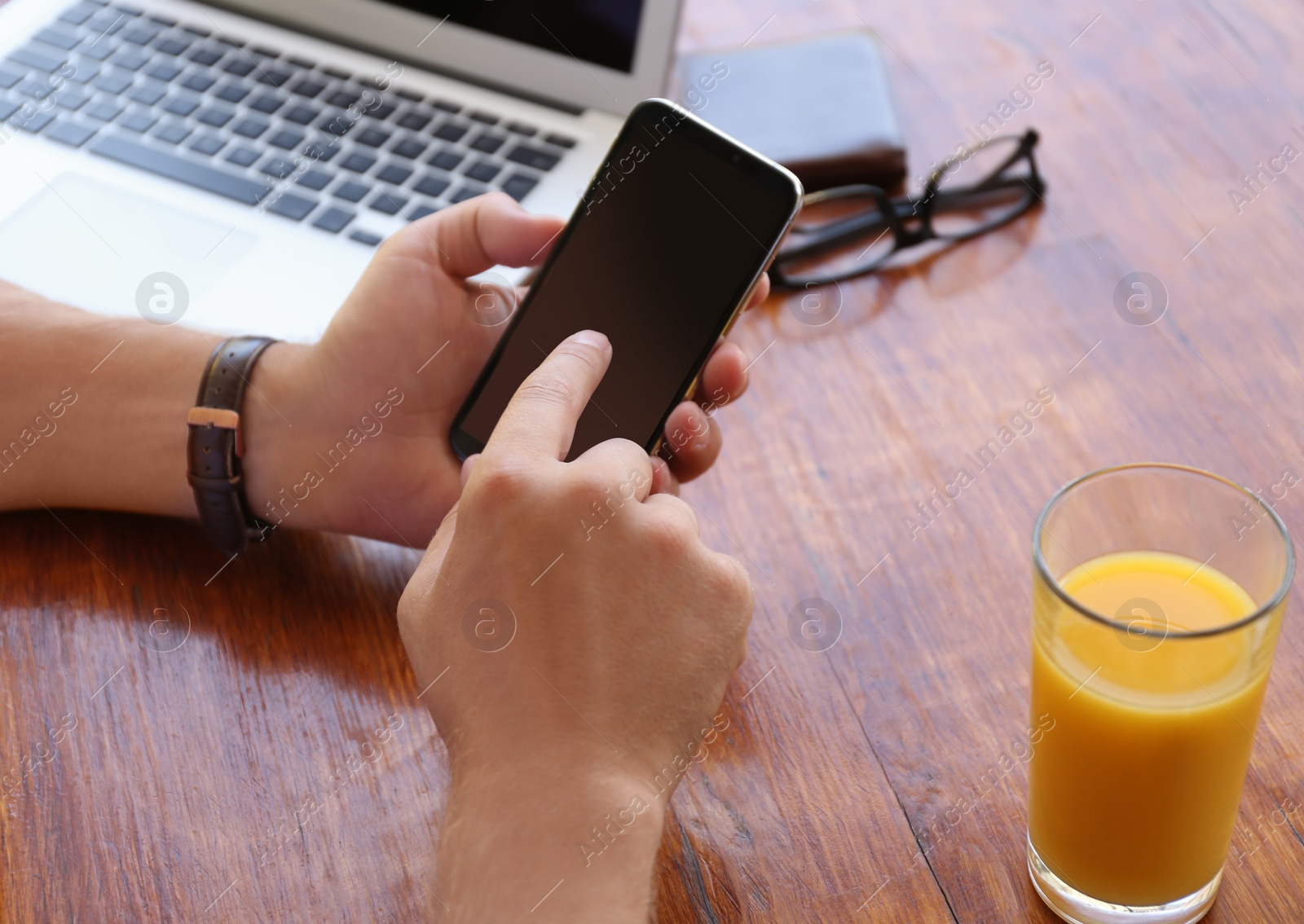 Photo of Man with smartphone at table in cafe, closeup