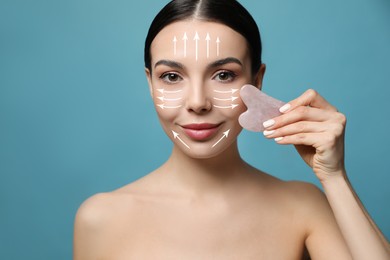 Image of Beautiful young woman doing facial massage with gua sha tool on blue background, closeup