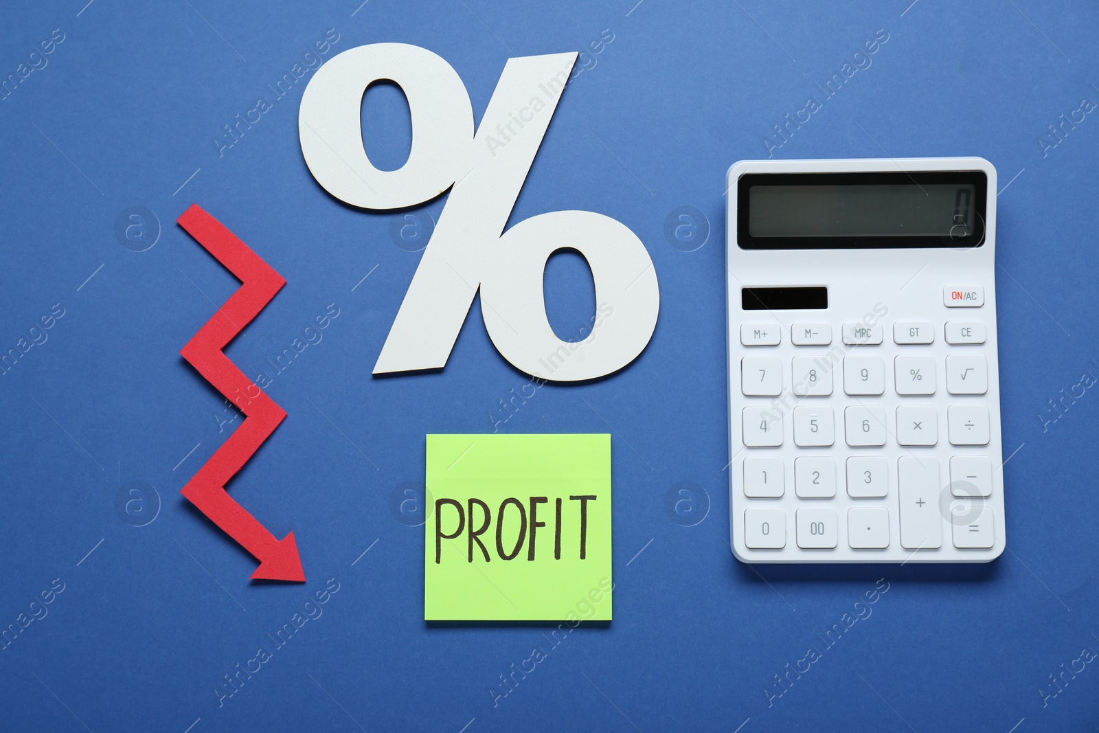 Photo of Sticky note with word Profit, calculator, percent symbol and up arrow on blue background, flat lay
