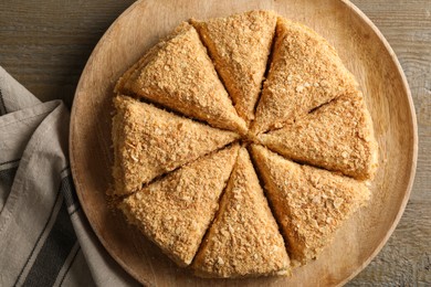 Delicious cut Napoleon cake on table, top view