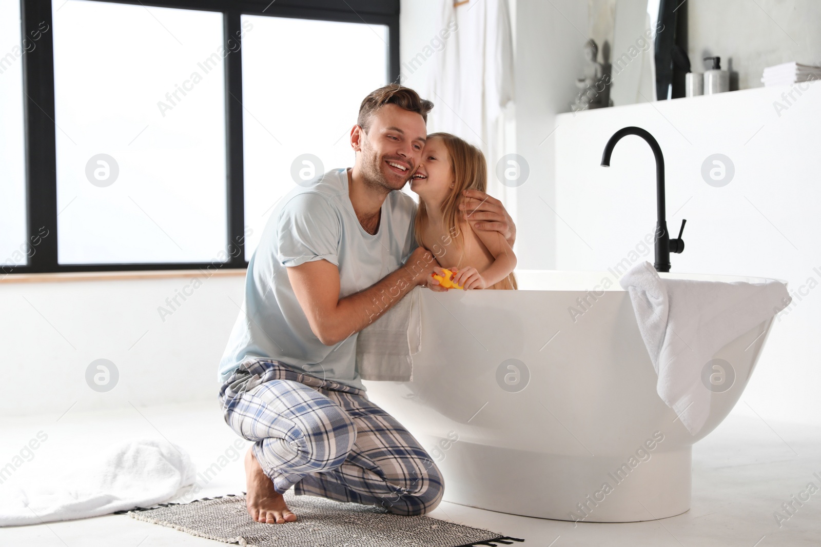 Photo of Father and his cute little daughter in bathroom