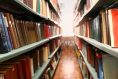 Blurred view of books on shelves in library