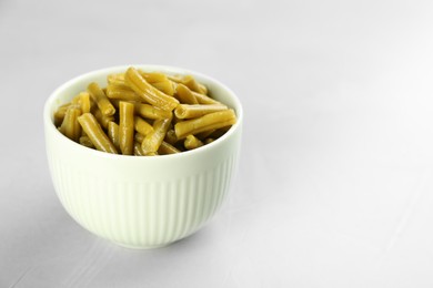 Canned green beans on light grey table. Space for text