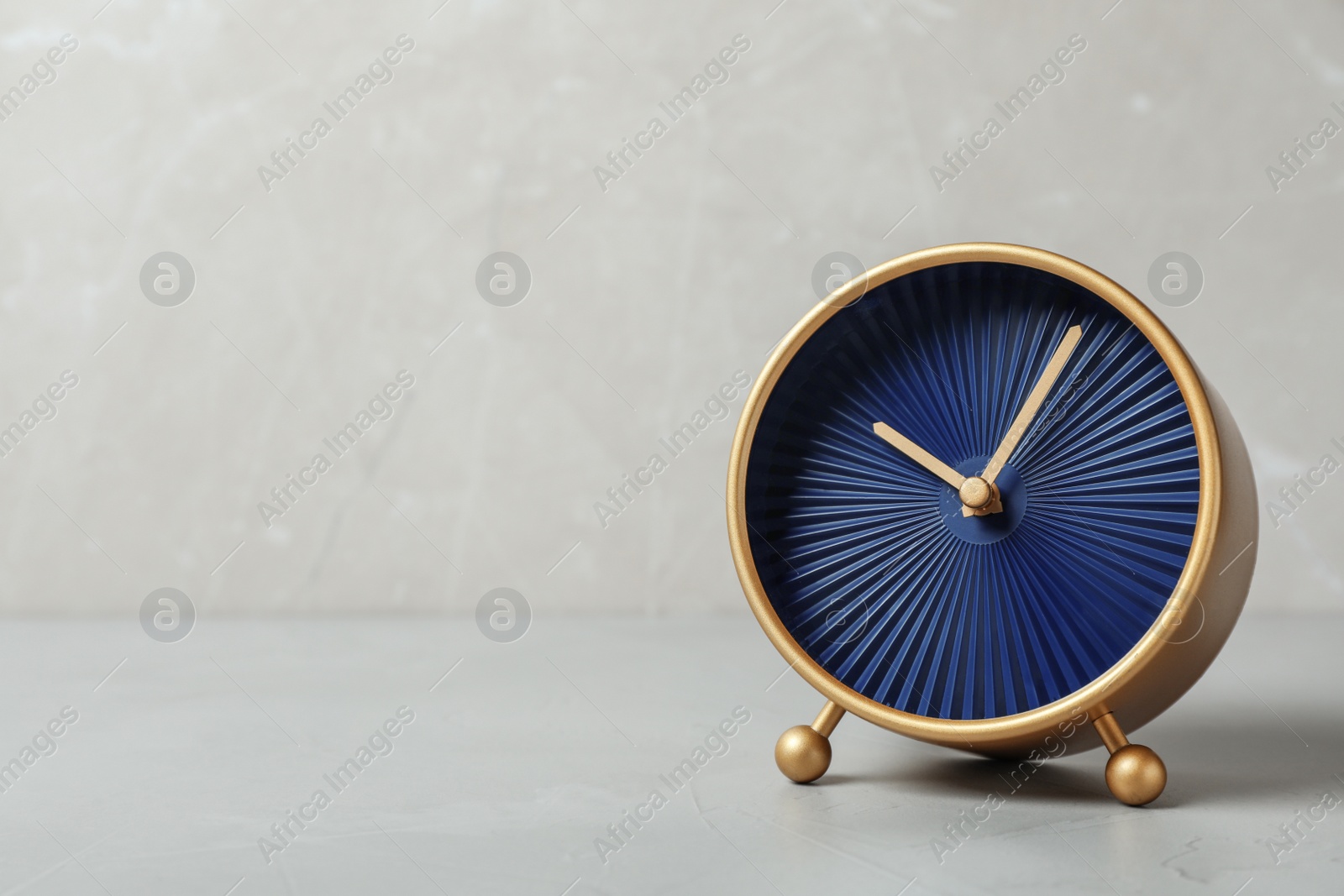 Photo of Alarm clock on grey background. Time management