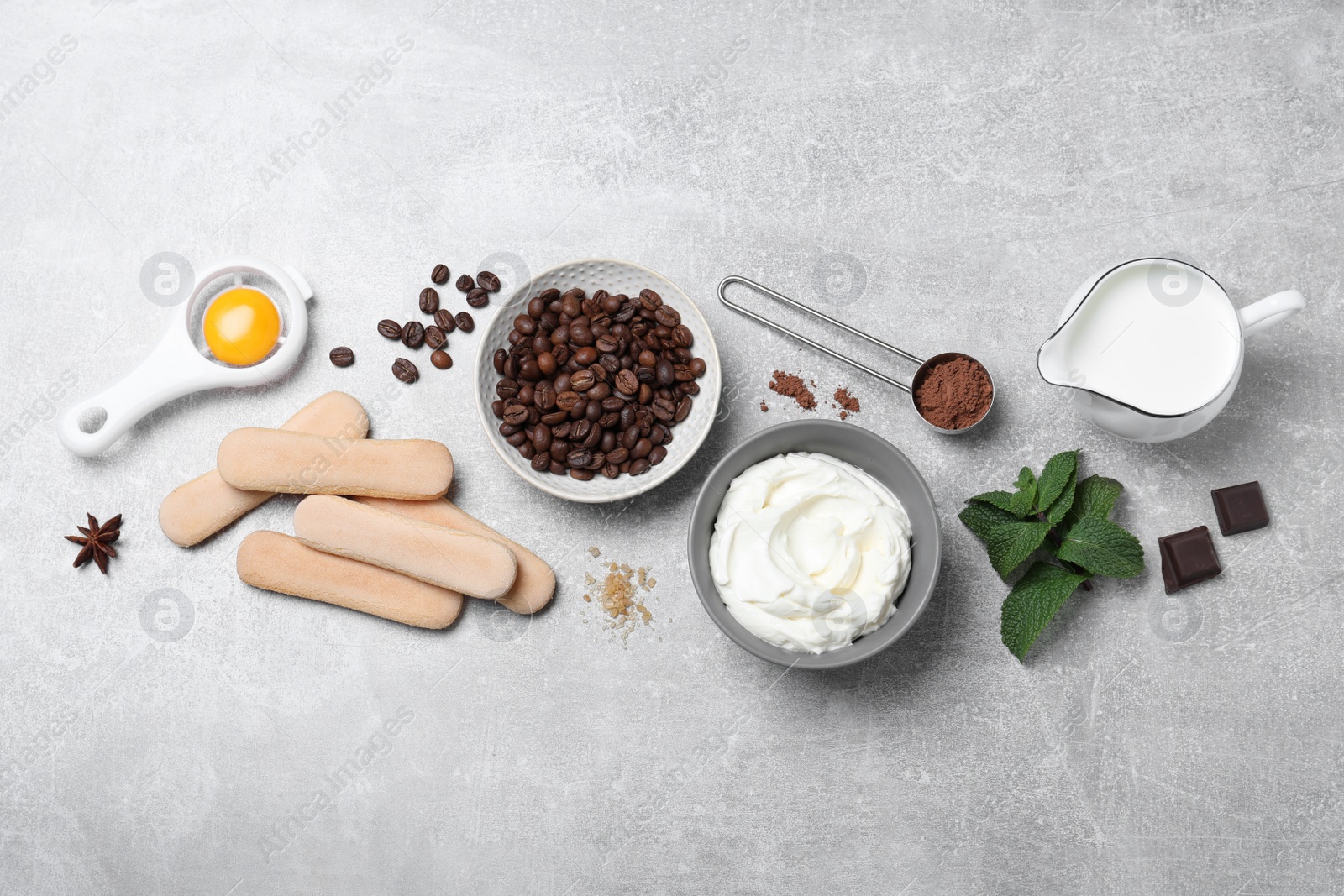 Photo of Flat lay composition with ingredients for tiramisu on grey table