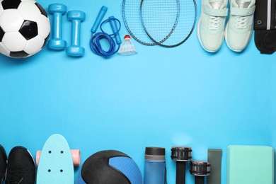 Different sports equipment on light blue background, flat lay. Space for text