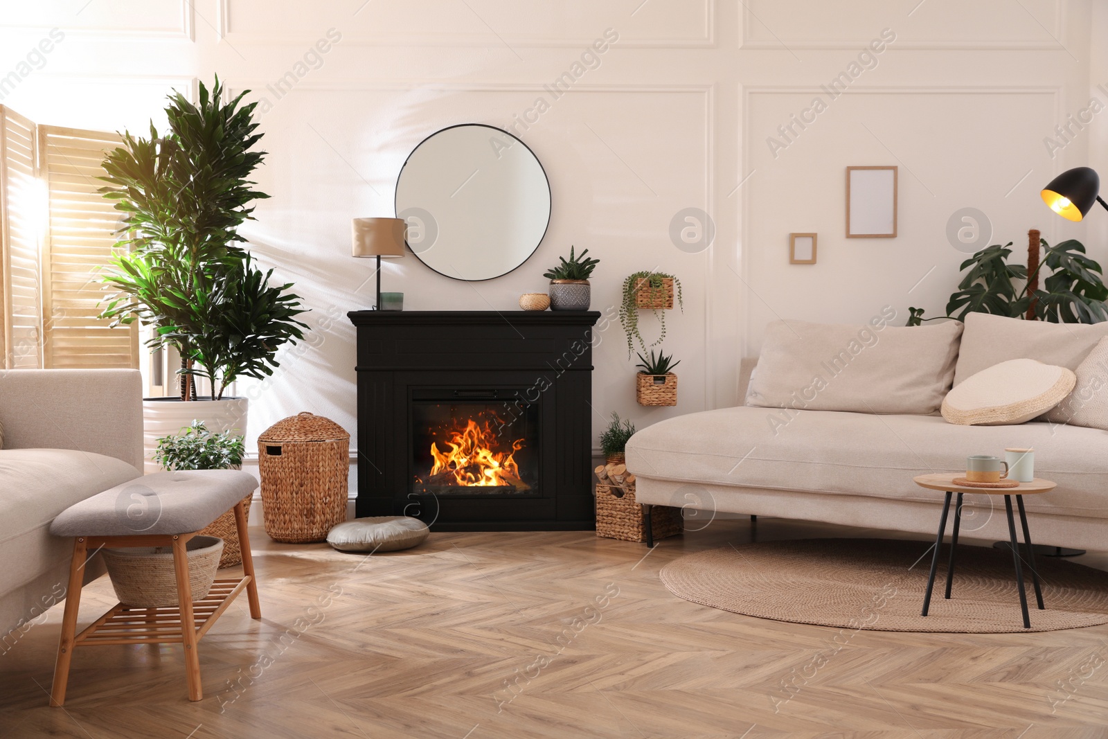 Photo of Stylish living room interior with electric fireplace, comfortable sofas and beautiful decor elements