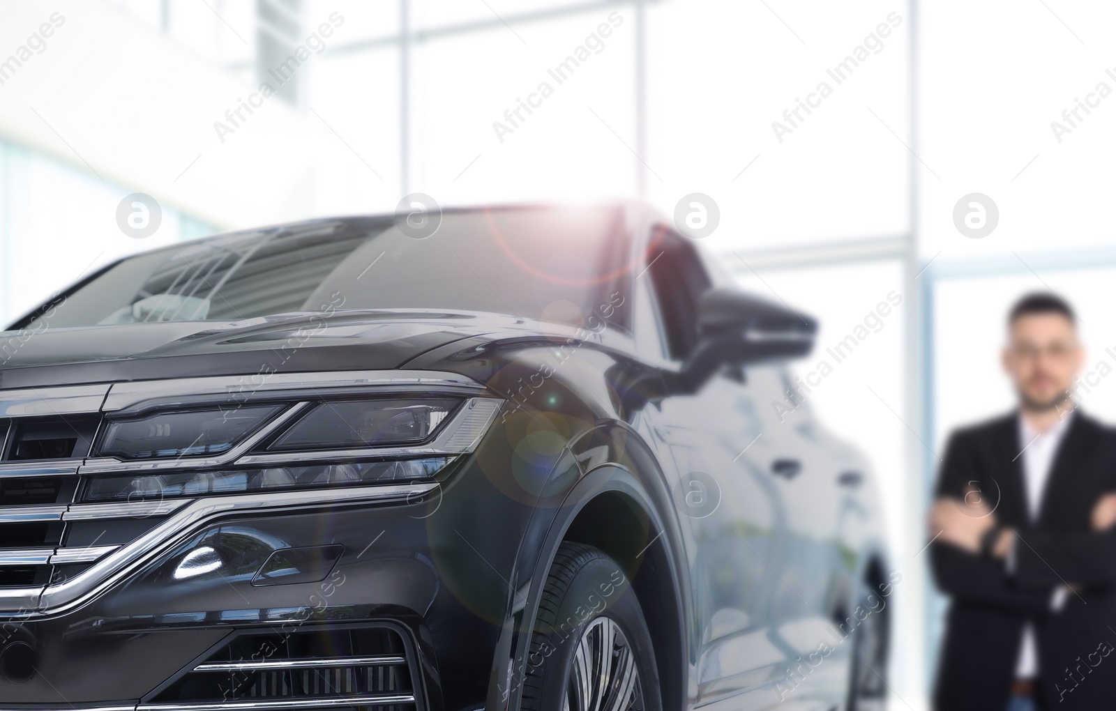 Image of Customer choosing and buying car in dealership, focus on new auto