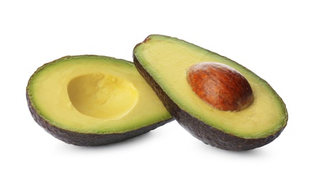 Photo of Cut ripe avocado with pit on white background