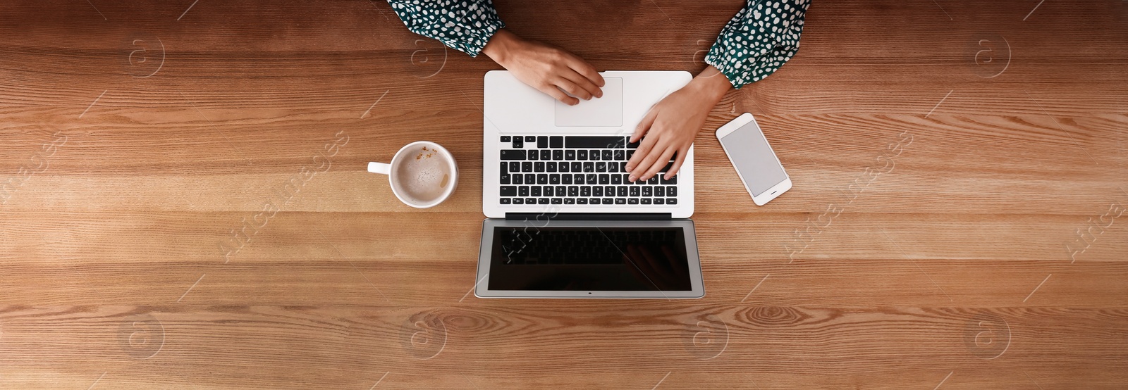 Image of Young woman working on computer at table indoors, top view. Banner design