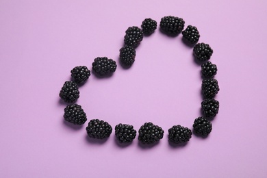 Photo of Composition with ripe blackberries on color background