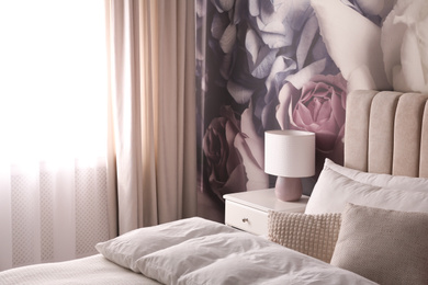 Photo of Stylish floral room interior with comfortable bed
