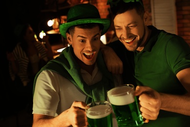 Photo of Men with beer celebrating St Patrick's day in pub