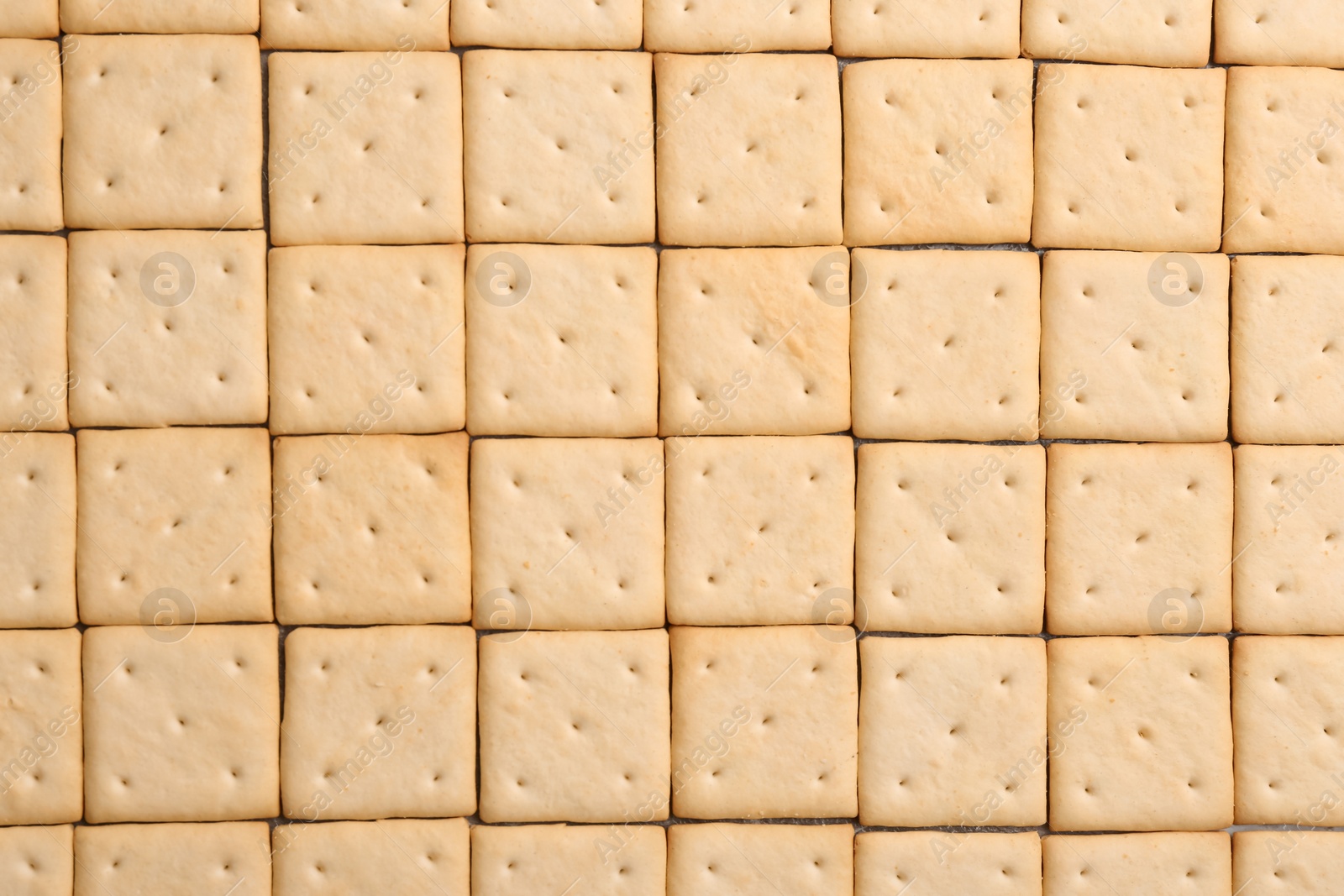 Photo of Many delicious crackers as background, top view