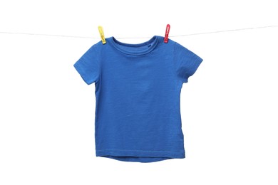 One blue t-shirt drying on washing line isolated on white