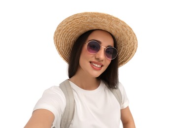 Photo of Smiling young woman in sunglasses and straw hat taking selfie on white background