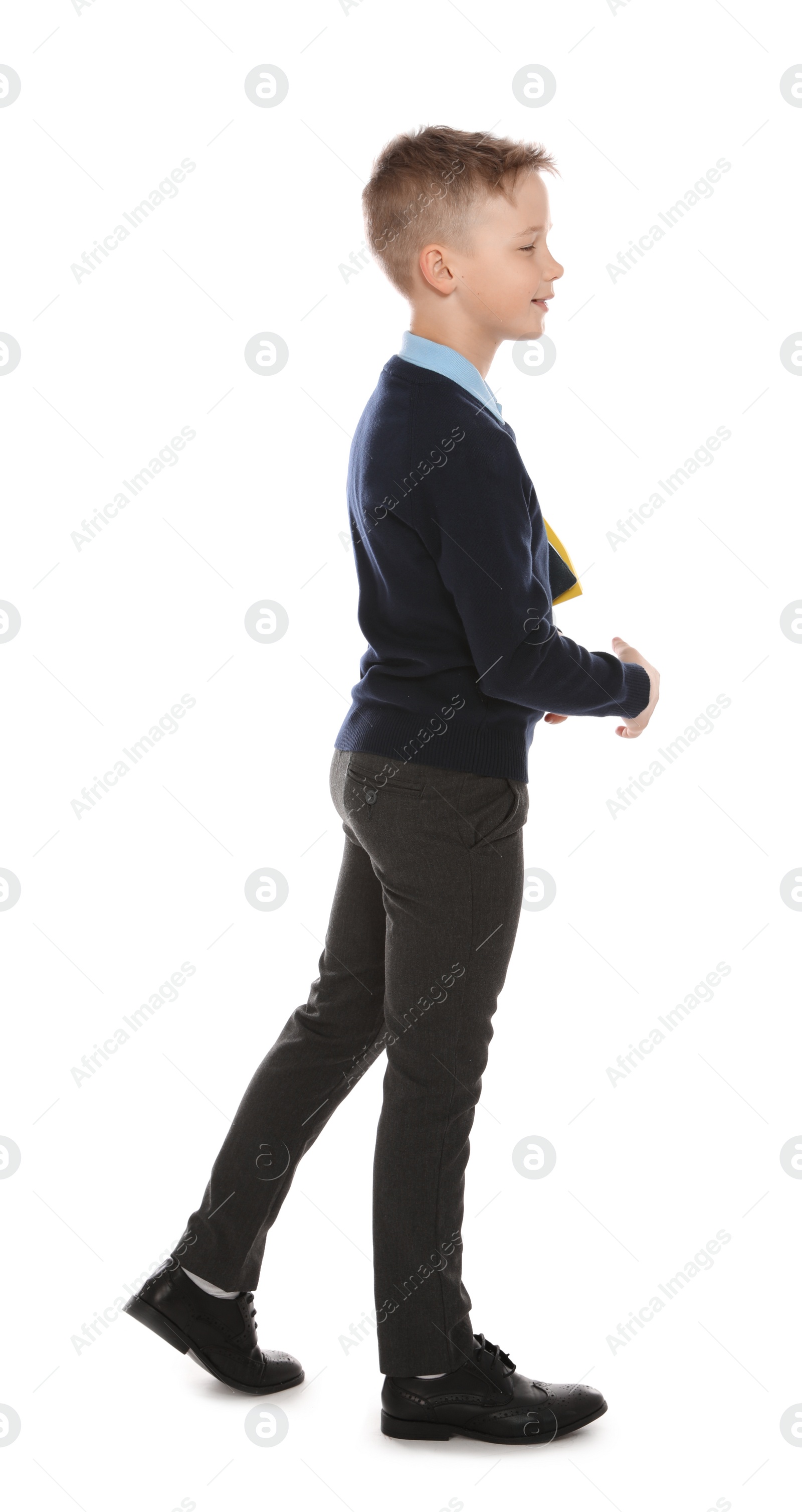 Photo of Full length portrait of cute boy in school uniform on white background