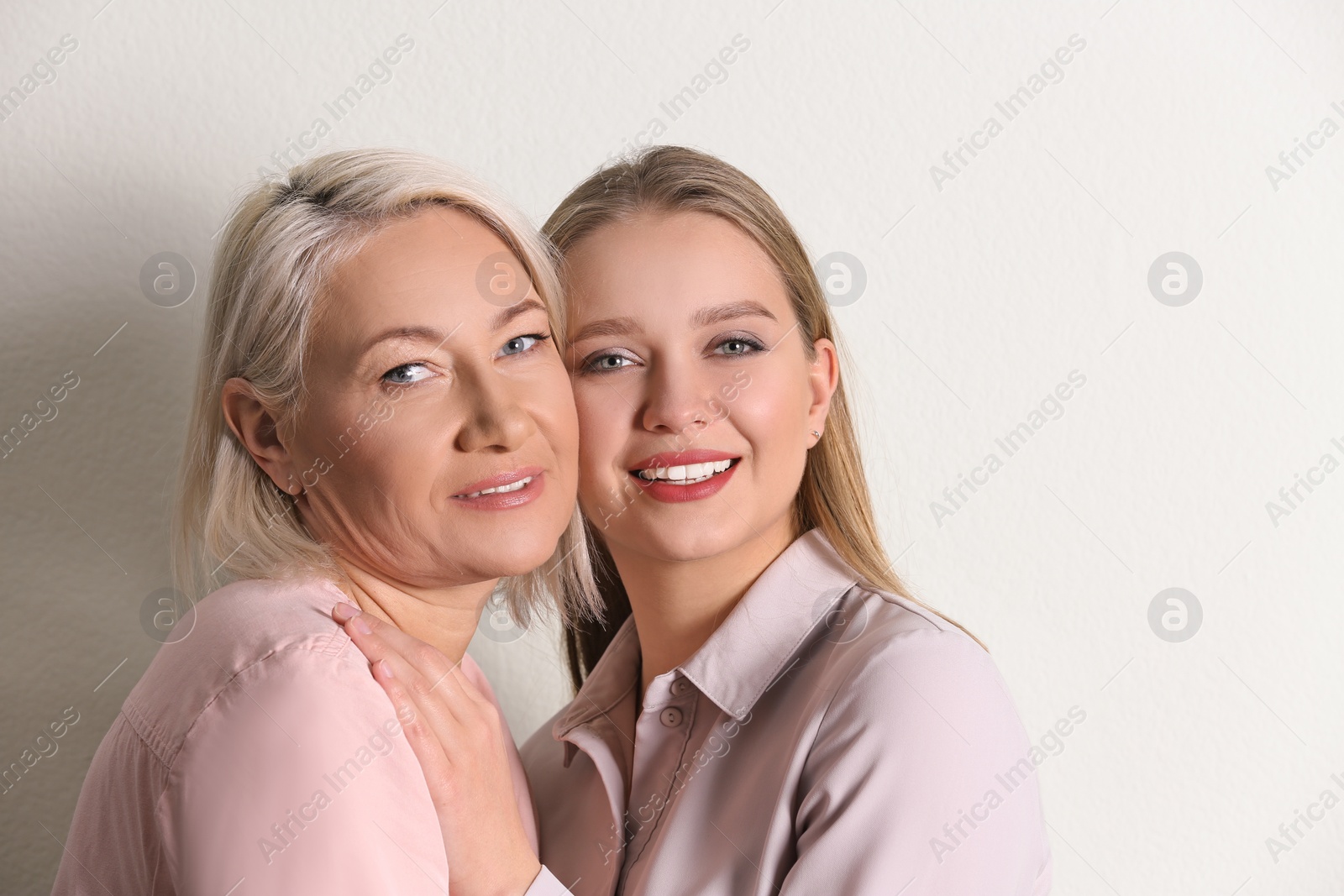 Photo of Mother and her adult daughter on white background