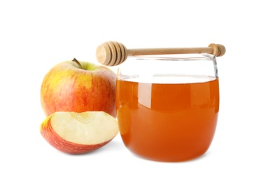 Glass jar with sweet honey and apples on white background