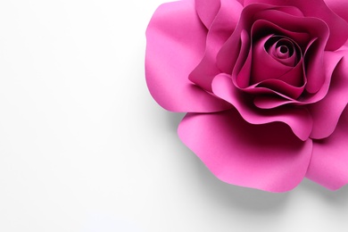 Photo of Beautiful pink flower made of paper on white background, top view