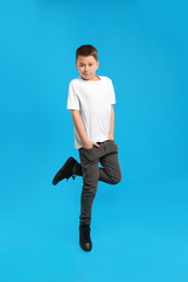 Photo of Preteen boy jumping on light blue background