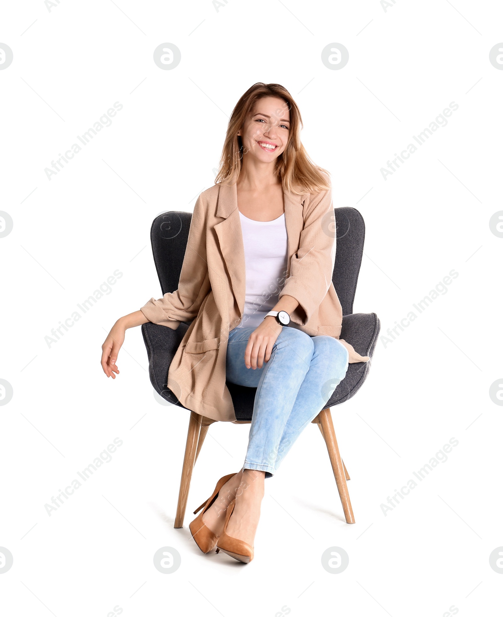 Photo of Young woman sitting in armchair on white background