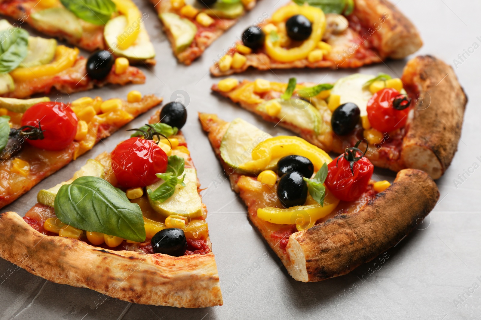 Photo of Delicious vegetable pizza on grey table, closeup