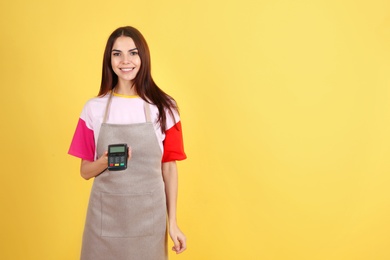 Photo of Waitress with payment terminal on color background. Space for text