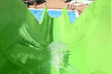 View from green slide in water park on sunny day