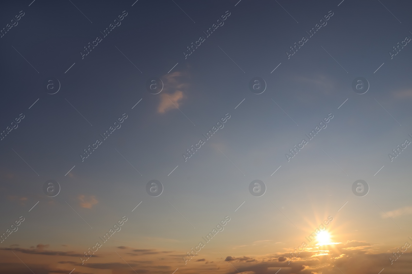 Photo of Picturesque view of beautiful blue sky with clouds at sunset