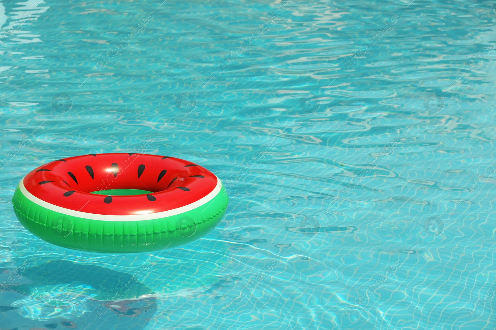 Photo of Inflatable ring floating in pool on sunny day