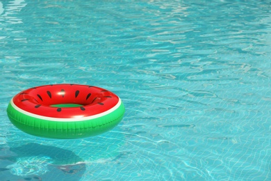 Inflatable ring floating in pool on sunny day