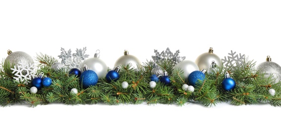 Fir tree branches with Christmas decoration on white background